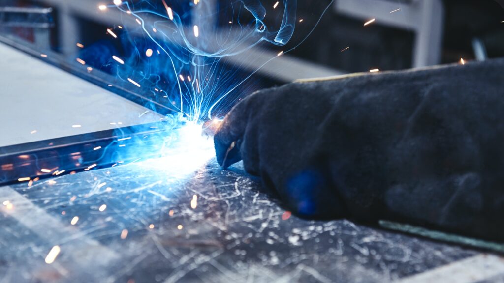 The better way to weld. Hand in glove hold welding steel. Welds with argon-arc welding
